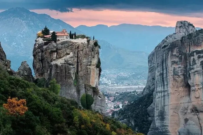 Framed Print : Scenic twilight view of the Monastery of the Holy Trinity in Meteora at sunset and Kalambaka town at the distance Framed Print : Scenic twilight view of the Monastery of the Holy Trinity in Meteora at sunset and Kalambaka town at the distance
