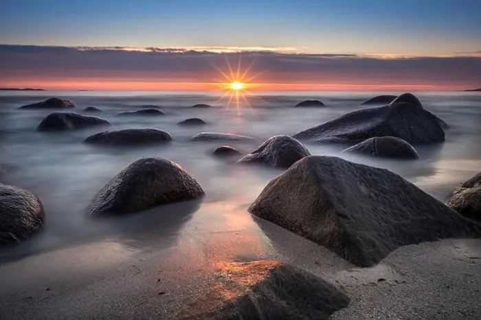 Framed Print : Scenic view from beach with stones and sunset at summer night in Lofoten, Norway