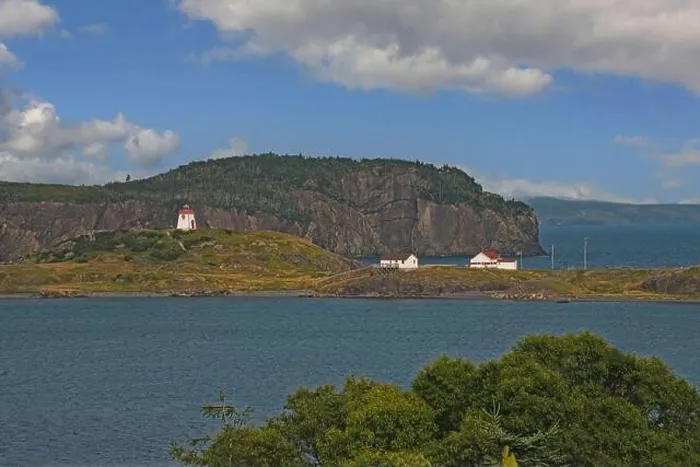 Framed Print : A scenic view of the Fort Point lighthouse standing on a small hill next to the coastal village of Trinity
