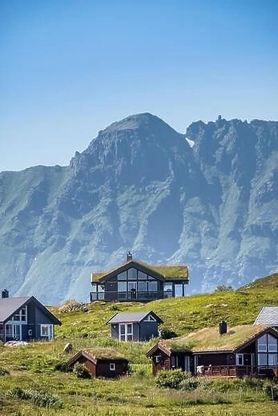 Scenic view from idyllic village with mountains at bright summer day in little village Lofoten, Norway