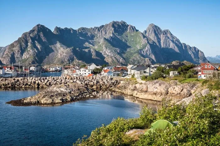 Framed Print : Scenic view from idyllic village with mountains at bright summer day in Henningsvaer, Lofoten, Norway Framed Print : Scenic view from idyllic village with mountains at bright summer day in Henningsvaer, Lofoten, Norway