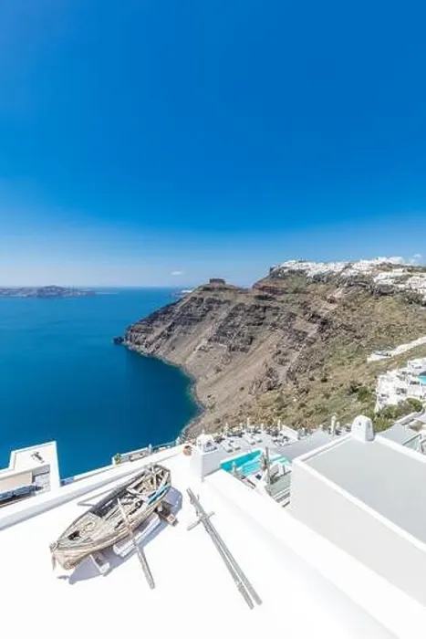 Framed Print : Scenic view of traditional cycladic resort with decoration boat foreground, Oia village, Santorini, Greece. Famous travel destination, luxury holiday Framed Print : Scenic view of traditional cycladic resort with decoration boat foreground, Oia village, Santorini, Greece. Famous travel destination, luxury holiday