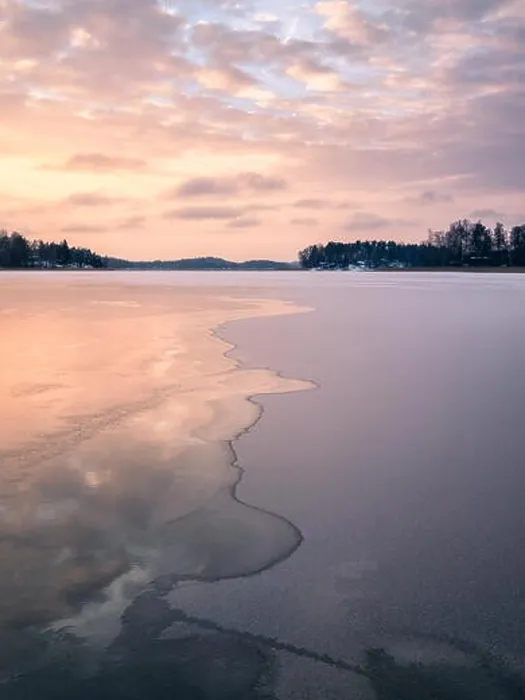 Framed Print : Scenic winter landscape with frozen lake and water at evening sunset in Finland Framed Print : Scenic winter landscape with frozen lake and water at evening sunset in Finland