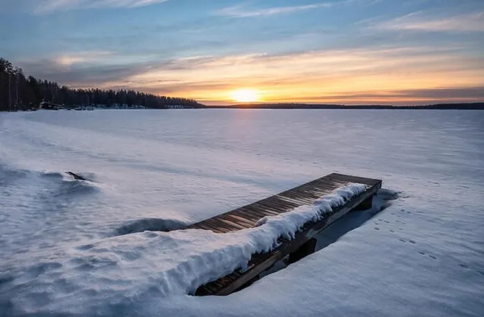 Framed Print : Scenic winter landscape with pier and sunset at evening light in Finland Framed Print : Scenic winter landscape with pier and sunset at evening light in Finland