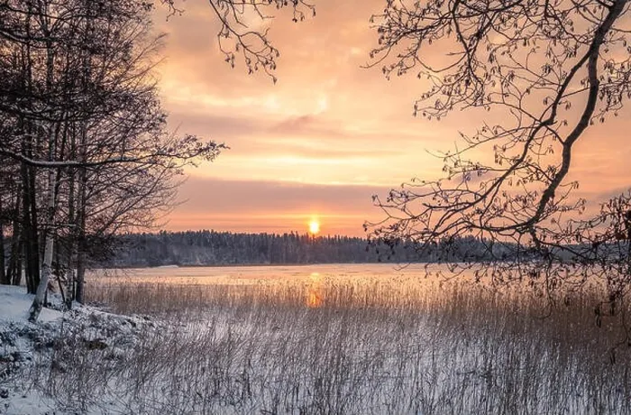 Framed Print : Scenic winter landscape with sunset at icy and peaceful lake in Finland Framed Print : Scenic winter landscape with sunset at icy and peaceful lake in Finland