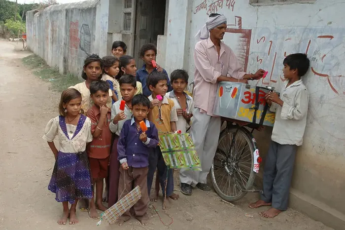 Framed Print : School going children eating red color ice cream in Village Manghawa District Narsinghpur Madhya Pradesh India - ANA Framed Print : School going children eating red color ice cream in Village Manghawa District Narsinghpur Madhya Pradesh India - ANA