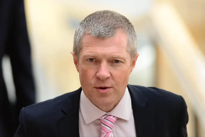 Framed Print : Scottish Liberal Democrat leader Willie Rennie makes his way to the chamber of the Scottish Parliament to listen to Framed Print : Scottish Liberal Democrat leader Willie Rennie makes his way to the chamber of the Scottish Parliament to listen to