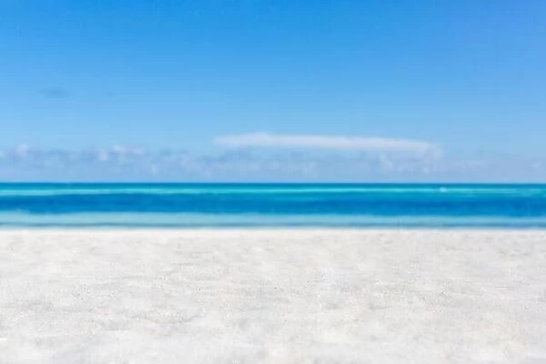 Sea sand sky concept. Closeup of sand on beach and blue summer sky, calmness and inspiration nature concept