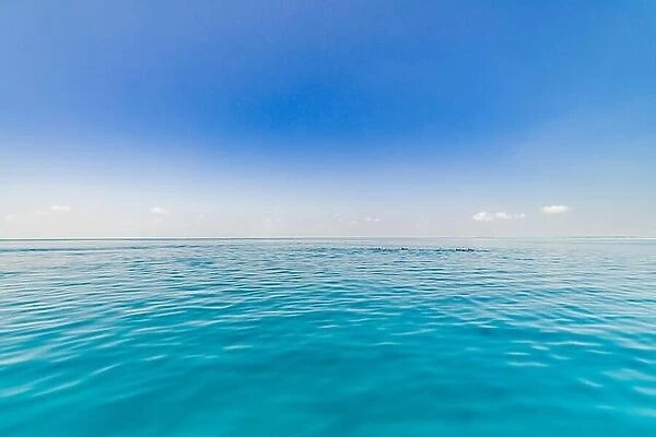 Seascape with sea horizon and almost clear deep blue sky
