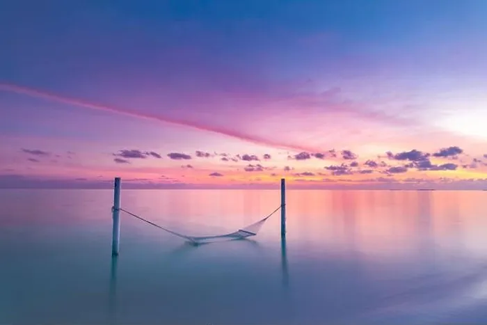 Framed Print : Seascape view of sunset over Maldives lagoon with empty hammock hanged over water. Sunset sea, luxury summer travel vacation scenery. Exotic beach Framed Print : Seascape view of sunset over Maldives lagoon with empty hammock hanged over water. Sunset sea, luxury summer travel vacation scenery. Exotic beach