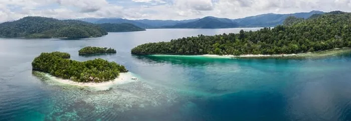 Framed Print : Seen from above, remote islands are surrounded by coral reefs in Raja Ampat, Indonesia. This region is known as the heart of the Coral Triangle Framed Print : Seen from above, remote islands are surrounded by coral reefs in Raja Ampat, Indonesia. This region is known as the heart of the Coral Triangle