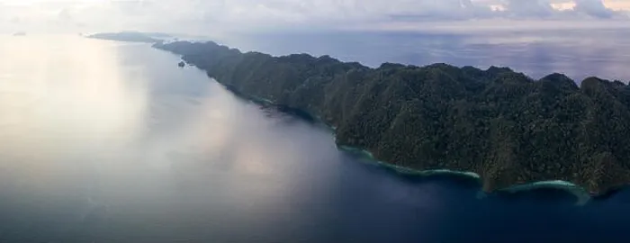 Framed Print : Seen from above, remote islands are surrounded by coral reefs in Raja Ampat, Indonesia. This region is known as the heart of the Coral Triangle Framed Print : Seen from above, remote islands are surrounded by coral reefs in Raja Ampat, Indonesia. This region is known as the heart of the Coral Triangle