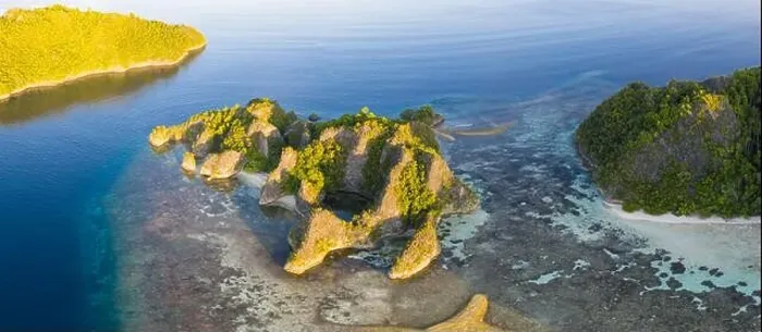 Framed Print : Seen from an aerial view, the tropical Pacific Ocean surrounds the rugged limestone islands scattered throughout the amazing seascape of Raja Ampat Framed Print : Seen from an aerial view, the tropical Pacific Ocean surrounds the rugged limestone islands scattered throughout the amazing seascape of Raja Ampat