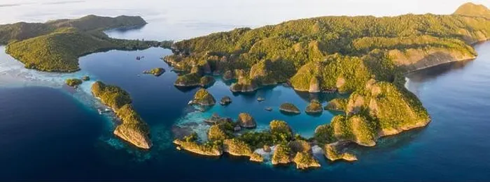 Framed Print : Seen from an aerial view, the tropical Pacific Ocean surrounds the rugged limestone islands scattered throughout the amazing seascape of Raja Ampat Framed Print : Seen from an aerial view, the tropical Pacific Ocean surrounds the rugged limestone islands scattered throughout the amazing seascape of Raja Ampat