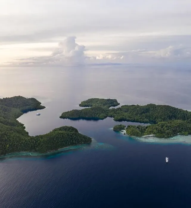 Framed Print : Seen from the air, healthy coral reefs surround tropical islands in Raja Ampat, Indonesia. This area is known for its incredible marine biodiversity