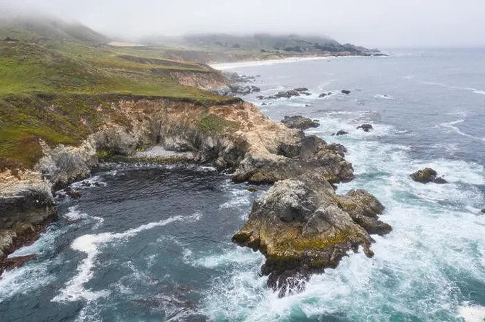 Framed Print : Seen from a bird's eye view, the cold waters of the Pacific Ocean wash against the rocky yet beautiful coast south of Monterey in Northern California Framed Print : Seen from a bird's eye view, the cold waters of the Pacific Ocean wash against the rocky yet beautiful coast south of Monterey in Northern California