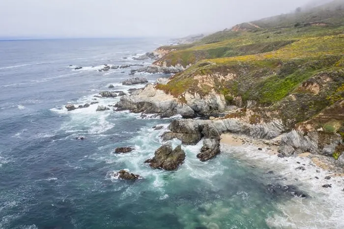 Framed Print : Seen from a bird's eye view, the cold waters of the Pacific Ocean wash against the rocky yet beautiful coast south of Monterey in Northern California Framed Print : Seen from a bird's eye view, the cold waters of the Pacific Ocean wash against the rocky yet beautiful coast south of Monterey in Northern California