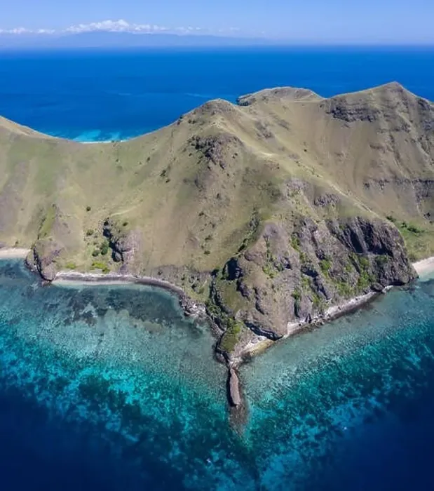 Framed Print : Seen from a bird's eye view, the blue Pacific Ocean surrounds the rugged island of Gili Banta Framed Print : Seen from a bird's eye view, the blue Pacific Ocean surrounds the rugged island of Gili Banta