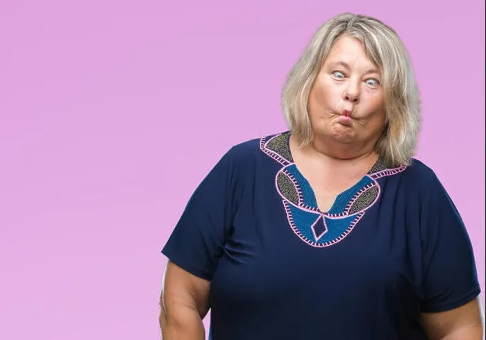 Framed Print : Senior plus size caucasian woman over isolated background making fish face with lips