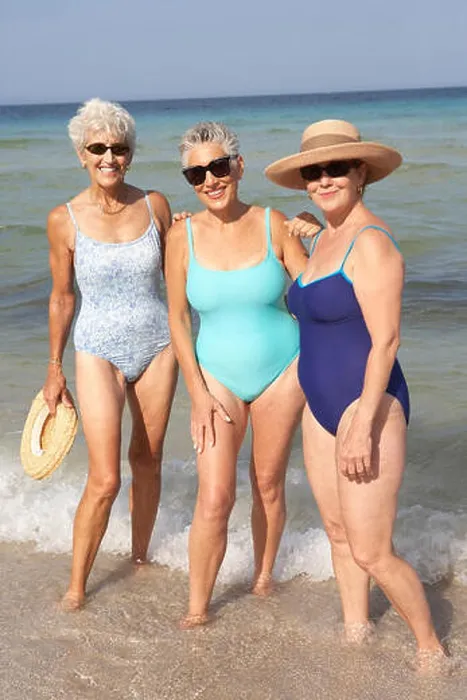 Framed Print : Senior women standing in waves on beach Framed Print : Senior women standing in waves on beach