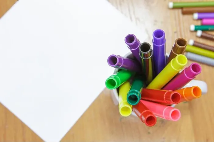 Framed Print : A set of colored markers and a sheet of white paper on the table Framed Print : A set of colored markers and a sheet of white paper on the table