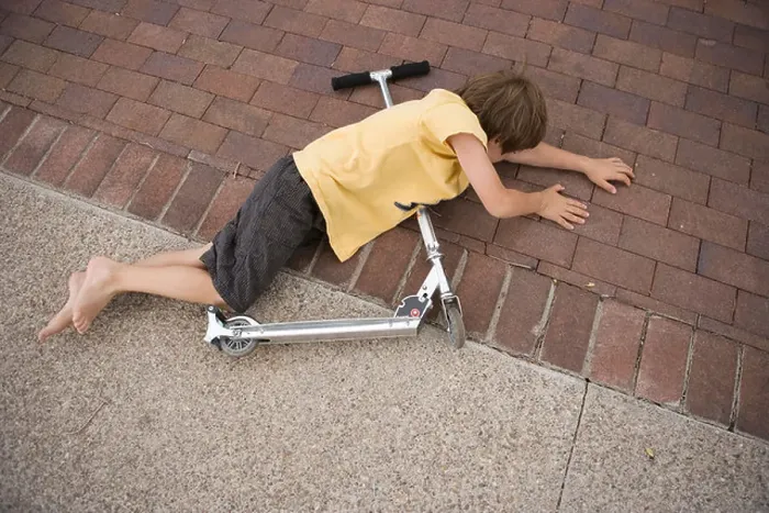 Framed Print : seven year old boy falls off his scooter and lands on the driveway Framed Print : seven year old boy falls off his scooter and lands on the driveway