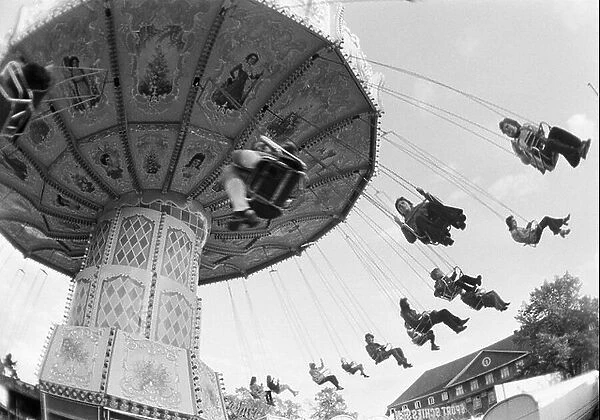 Seventies, black and white photo, kermess, people on a chairoplane
