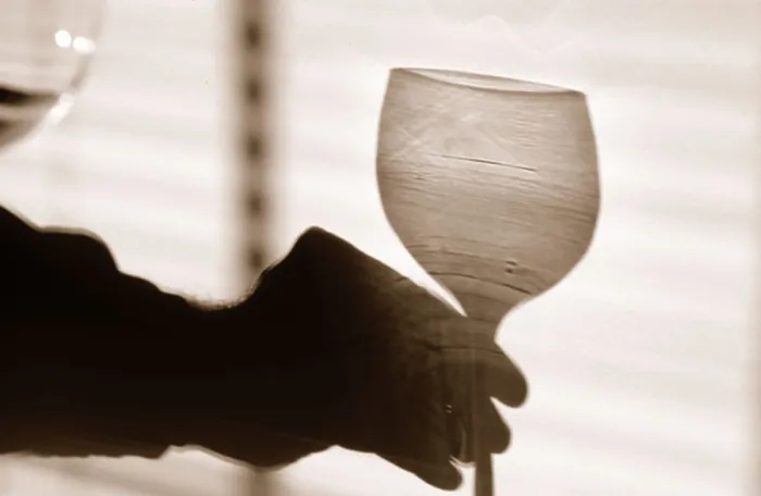 Framed Print : Shadow of a hand holding a glass of wine Framed Print : Shadow of a hand holding a glass of wine
