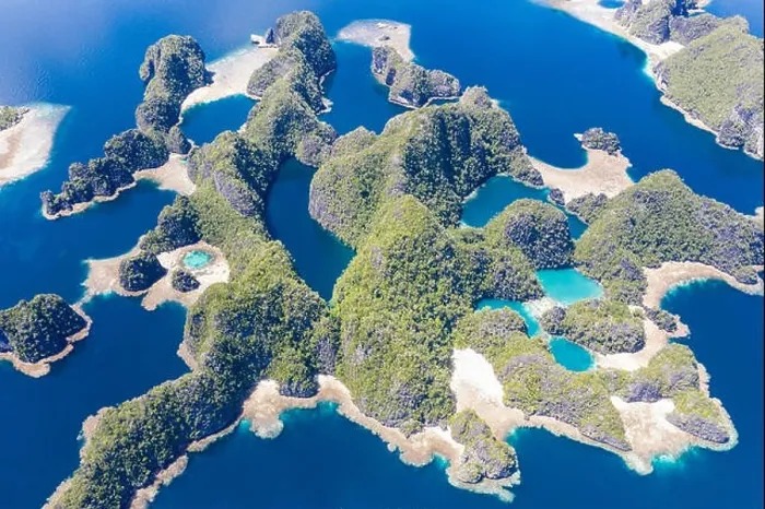 Framed Print : Shallow coral reefs surround remote limestone islands in Raja Ampat, Indonesia. This biodiverse region is known as the heart of the Coral Triangle Framed Print : Shallow coral reefs surround remote limestone islands in Raja Ampat, Indonesia. This biodiverse region is known as the heart of the Coral Triangle