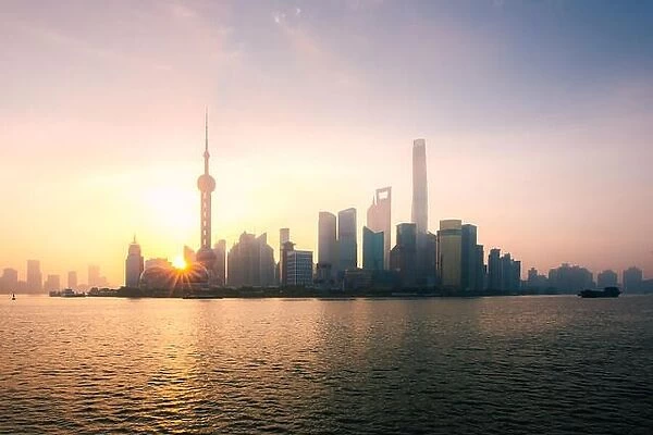 Shanghai, China city skyline during sunrise on the Huangpu River