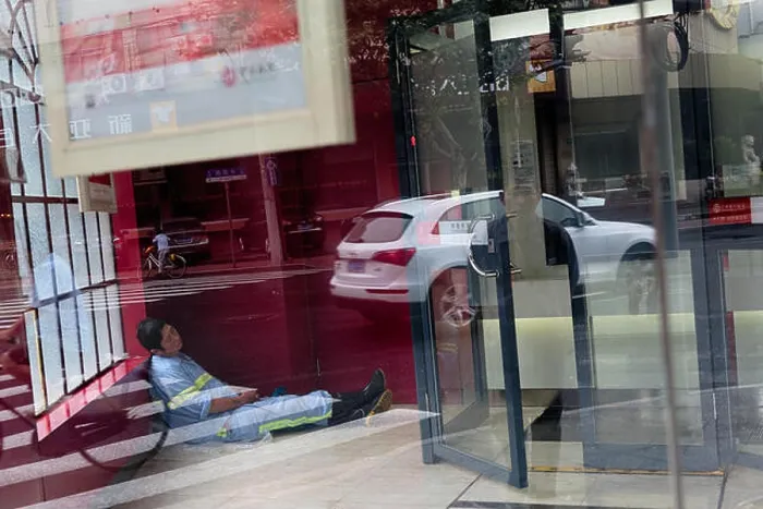 Framed Print : Shangia, China - October 5, 2015: Сhinese worker sleeps in a close office in Wukang Mansion in Shanghai, China Framed Print : Shangia, China - October 5, 2015: Сhinese worker sleeps in a close office in Wukang Mansion in Shanghai, China