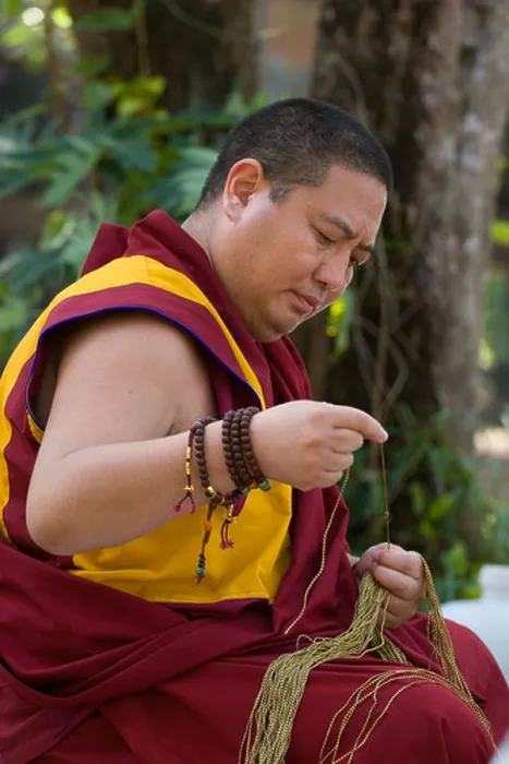 Framed Print : Shechen Rabjam Rinpoche prepares blessing strings at the one year anniversary Puja at Golden Buddha Beach THAILAND Framed Print : Shechen Rabjam Rinpoche prepares blessing strings at the one year anniversary Puja at Golden Buddha Beach THAILAND