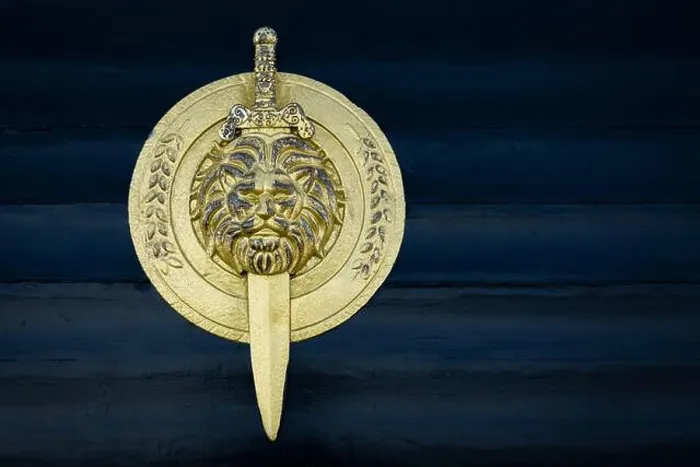 Framed Print : Shield with lion head isolated on dark wooden background Framed Print : Shield with lion head isolated on dark wooden background