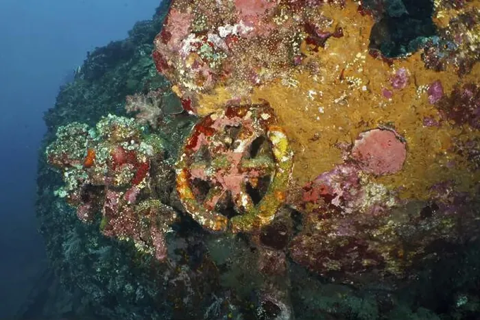 Framed Print : A part of a shipwreck with rust and coral that tells a past story underwater