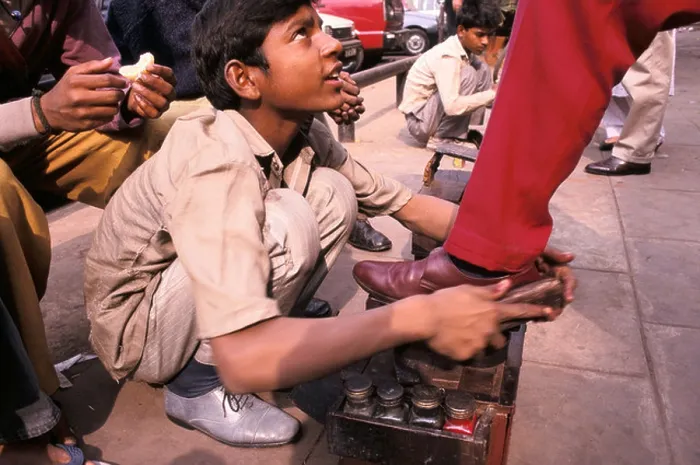 Framed Print : a shoe shine boy at work in connaught place new delhi india Framed Print : a shoe shine boy at work in connaught place new delhi india