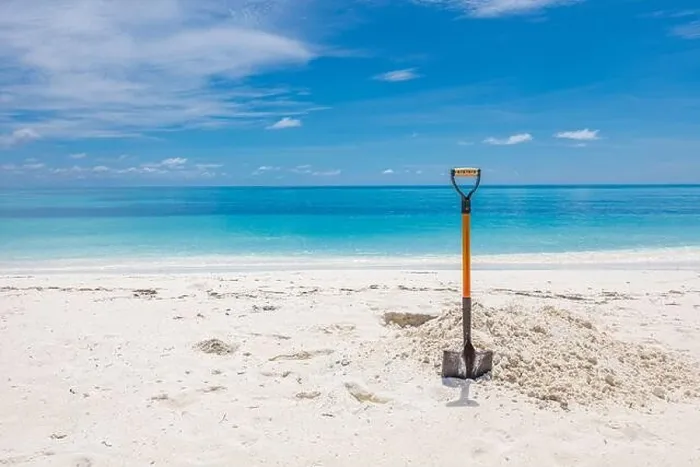 Framed Print : Shovel in Sand at the Beach. Wide angle image of a shovel in the sand on a beach under a partly cloudy blue sky Framed Print : Shovel in Sand at the Beach. Wide angle image of a shovel in the sand on a beach under a partly cloudy blue sky
