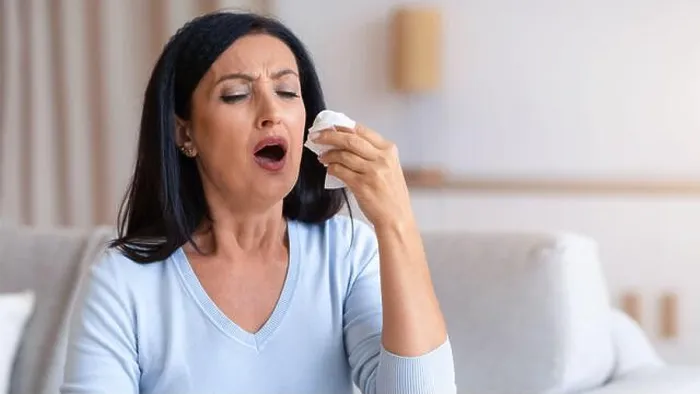 Framed Print : Sick mature woman sneezing and couching, holding tissue paper