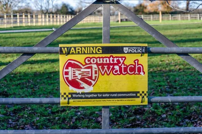 Framed Print : A sign attached to a metal gate on the entrance to a field warns people that a country watch is in force in this area Framed Print : A sign attached to a metal gate on the entrance to a field warns people that a country watch is in force in this area