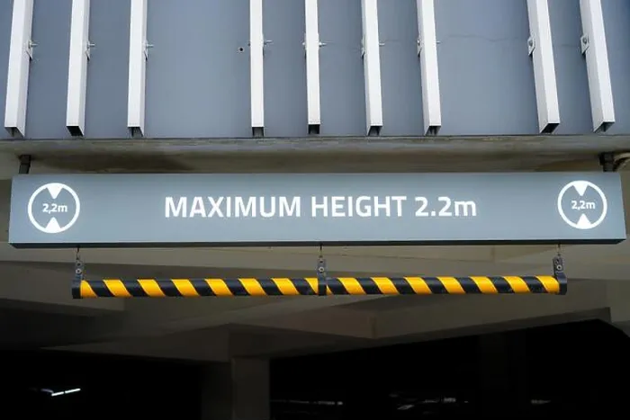 Framed Print : Sign: Maximum Height 2.2m, red and white, hanging from carpark ceiling Framed Print : Sign: Maximum Height 2.2m, red and white, hanging from carpark ceiling