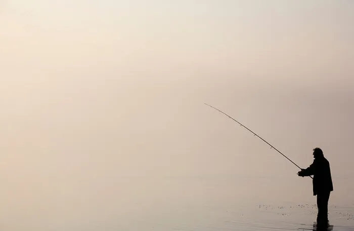 Framed Print : The silhouette of a lone angler fishing in Bassenthwaite Lake in the Lake District Framed Print : The silhouette of a lone angler fishing in Bassenthwaite Lake in the Lake District