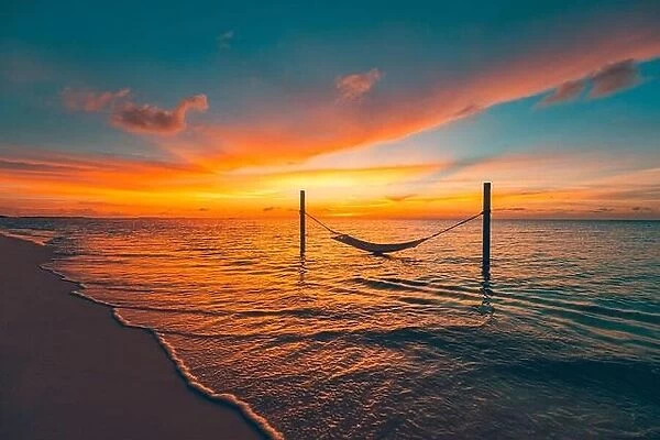 Silhouette of over water hammock with amazing stunning water reflection and seascape, skyscape. Beautiful sunset on the tropical sea beach background