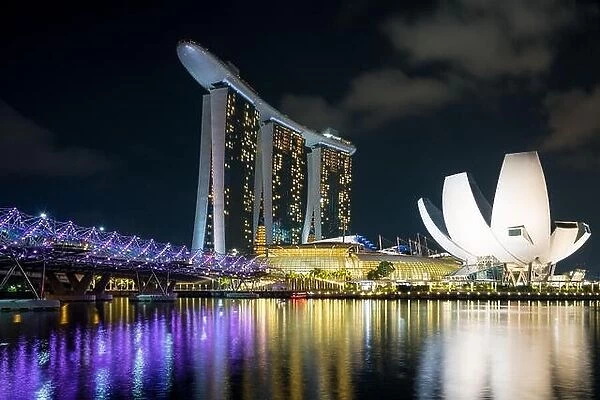 Singapore business district skyline with helix bridge in night at Marina Bay, Singapore