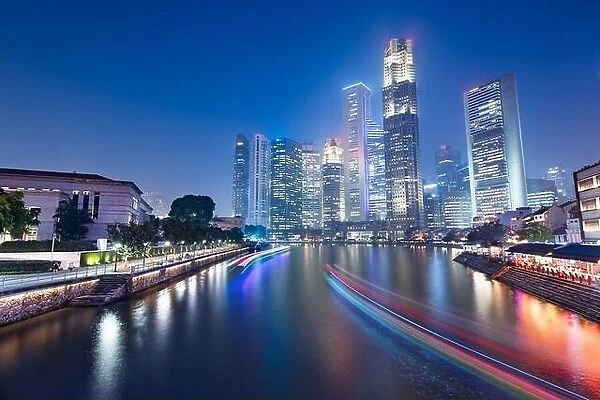 Singapore skyline and canal at night