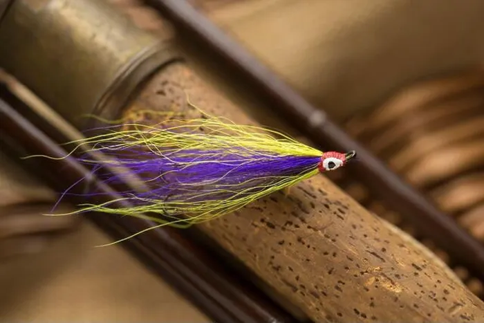 Framed Print : A single salmon fly that was probably homemade on the cork handle of an old wooden salmon fly fishing rod Framed Print : A single salmon fly that was probably homemade on the cork handle of an old wooden salmon fly fishing rod