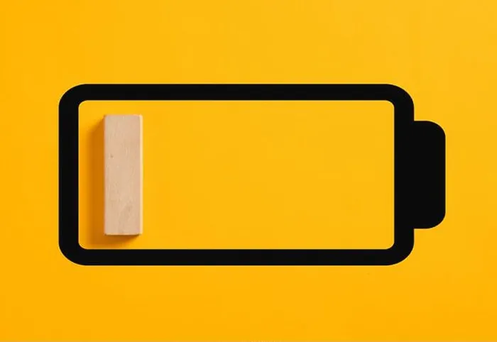 Framed Print : Single wooden block representing the charging status on a battery icon with low battery level