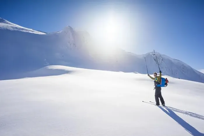 Framed Print : Skier lifts poles in the air, fully enjoying a blue bird winter day Framed Print : Skier lifts poles in the air, fully enjoying a blue bird winter day