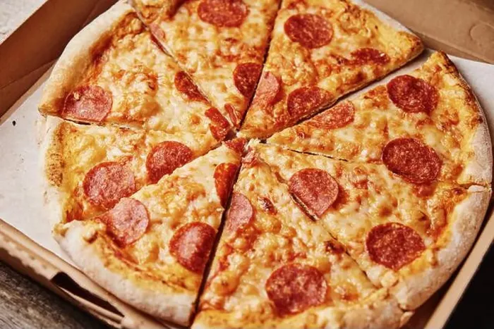 Framed Print : Slice of pizza in cardboard box, close up Framed Print : Slice of pizza in cardboard box, close up