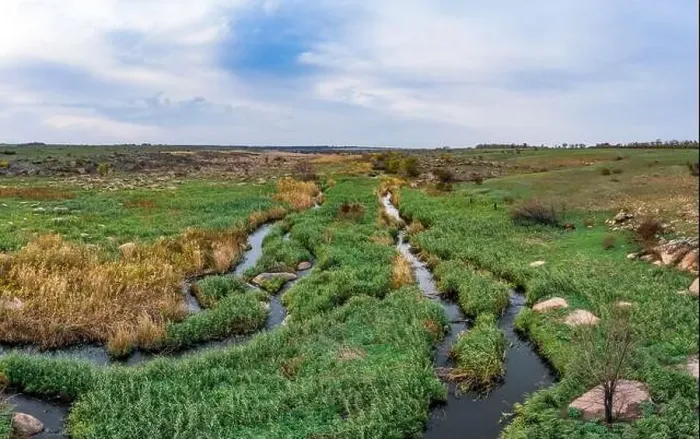 Framed Print : A small fast stream Kamenka in the wilderness in the evening light in Ukraine. Aerial panoramic drone shot