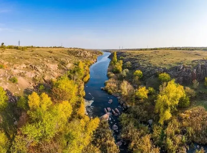 Framed Print : A small fast stream Kamenka in the wilderness in the evening light in Ukraine. Aerial panoramic drone shot Framed Print : A small fast stream Kamenka in the wilderness in the evening light in Ukraine. Aerial panoramic drone shot