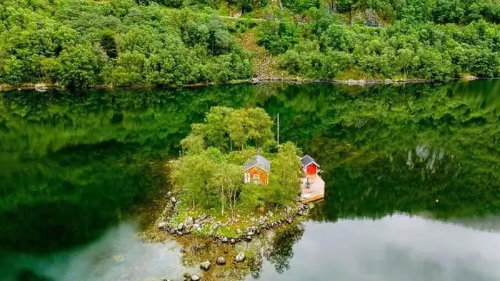 Framed Print : small, green island with two red cabins nestled amongst trees in a secluded Norwegian fjord Framed Print : small, green island with two red cabins nestled amongst trees in a secluded Norwegian fjord